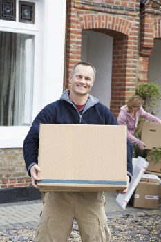 Flat removals team working in a Chelsea street with boxes and furniture