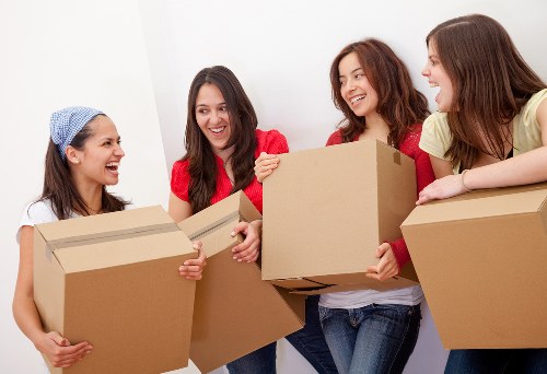 A professional team handling an upright piano move in a Chelsea property