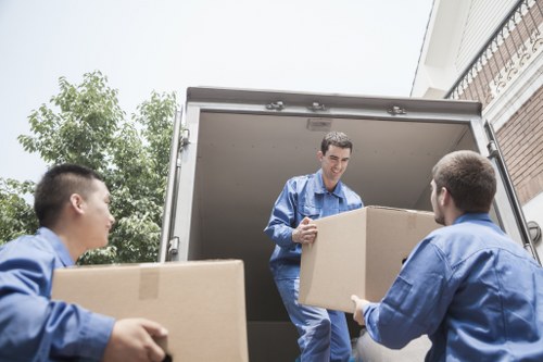 Moving team preparing a job near a busy Chelsea street